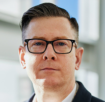 Alexander Hughes, výkonný ředitel obchodní platformy kryptoměn, portrét.